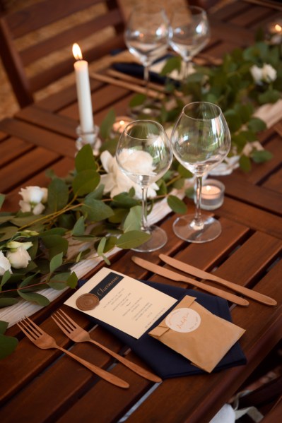 Close up of table white roses wine cutlery